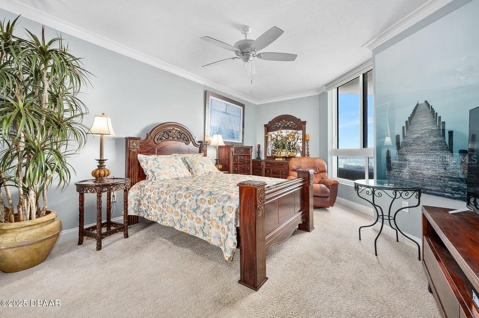 231 Riverside Drive, Unit 15071 Daytona Beach, FL 32117 - Photo 30 of 53 a bed room with furniture and a chandelier