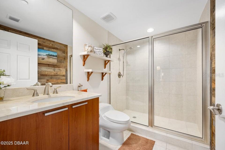 231 Riverside Drive, Unit 15071 Daytona Beach, FL 32117 - Photo 31 of 53 a bathroom with a sink a toilet and shower