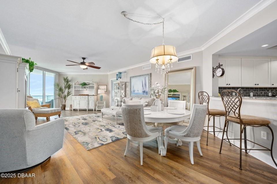231 Riverside Drive, Unit 15071 Daytona Beach, FL 32117 - Photo 6 of 53 a view of a dining room with furniture wooden floor and chandelier
