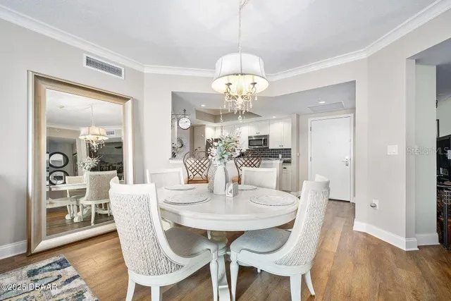 a view of a dining room with furniture wooden floor and chandelier