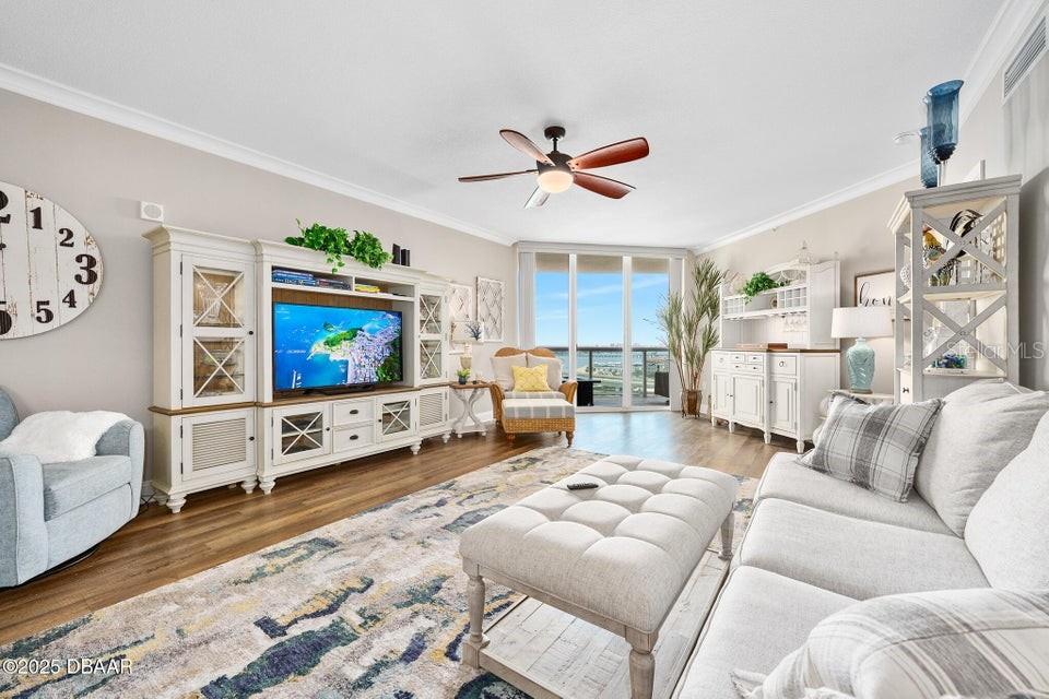 231 Riverside Drive, Unit 15071 Daytona Beach, FL 32117 - Photo 9 of 53 a living room with furniture and a flat screen tv