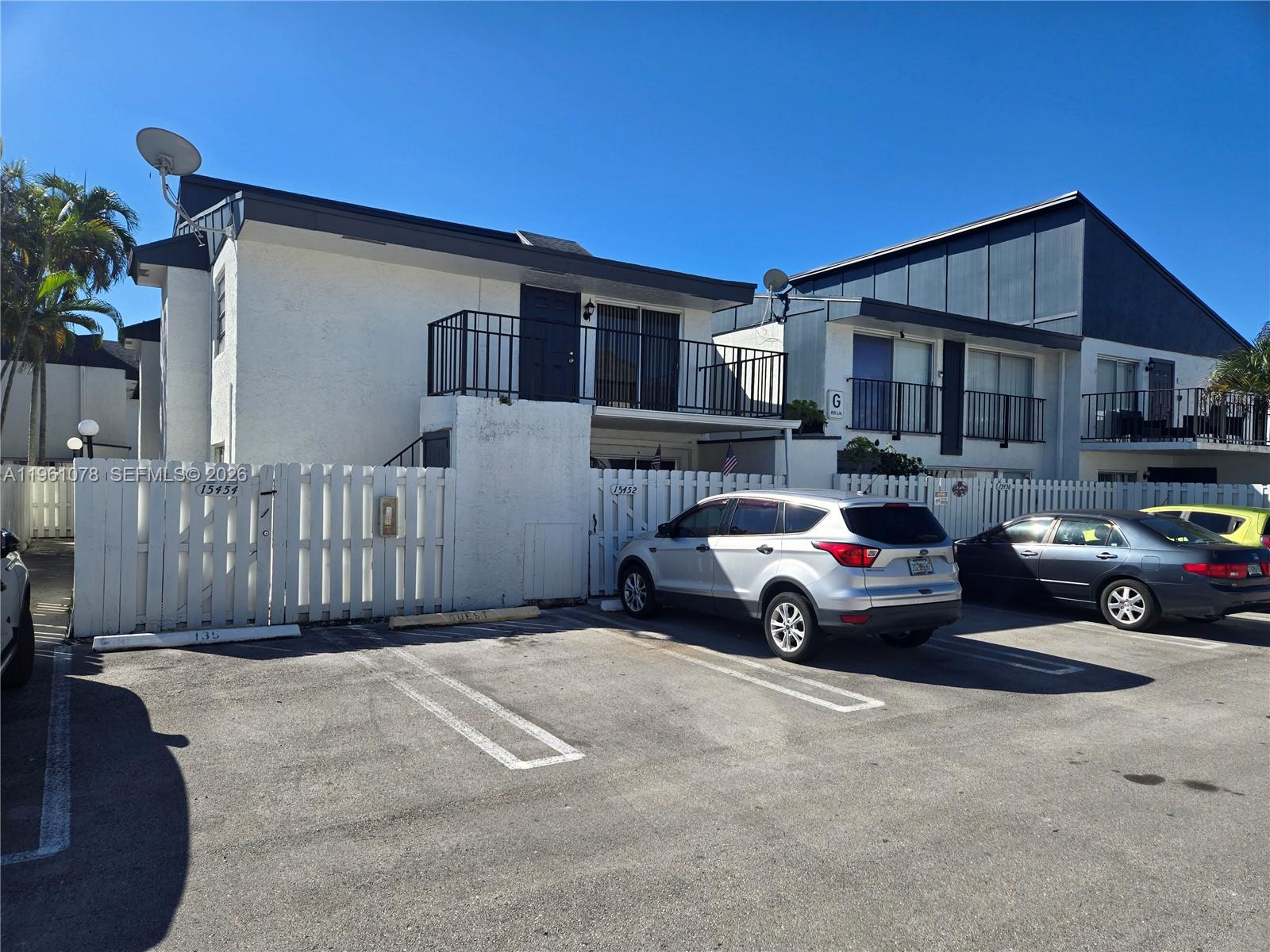 15454 Southwest 85th Lane, Unit 135 Miami, FL 33193 - Photo 1 of 17 a car parked in front of a house