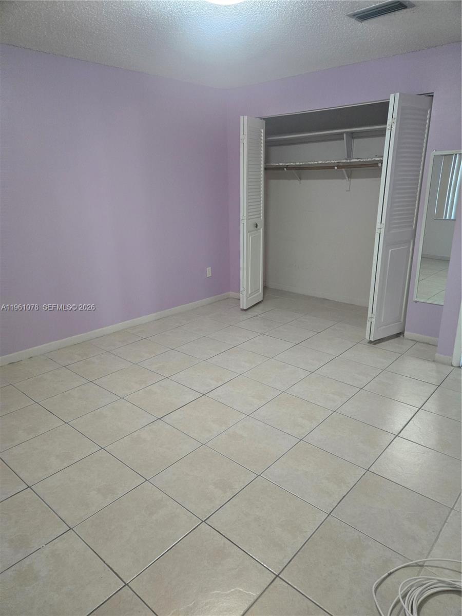 15454 Southwest 85th Lane, Unit 135 Miami, FL 33193 - Photo 15 of 17 a view of an empty room and a window