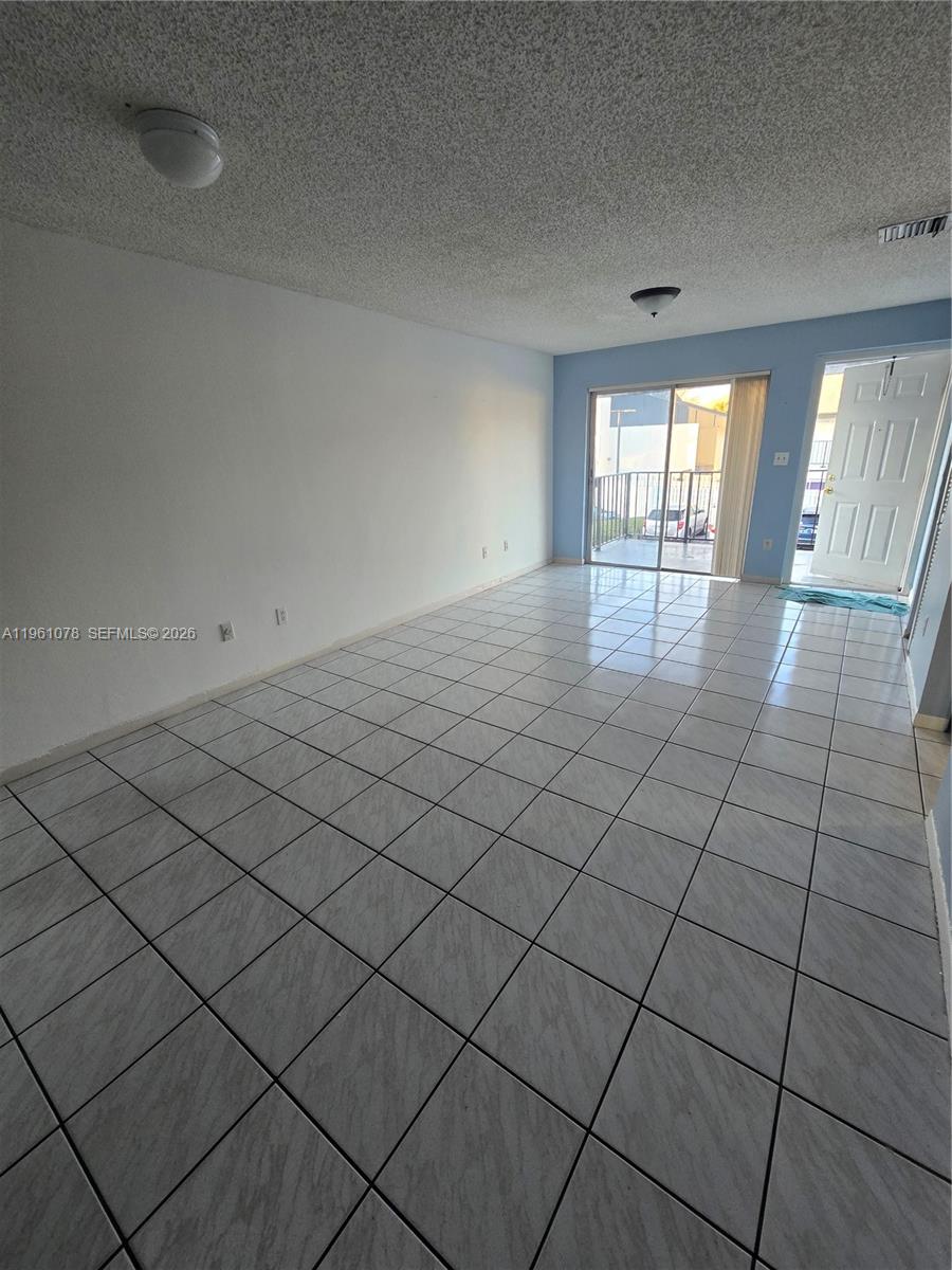 15454 Southwest 85th Lane, Unit 135 Miami, FL 33193 - Photo 10 of 17 a view of an empty room and window