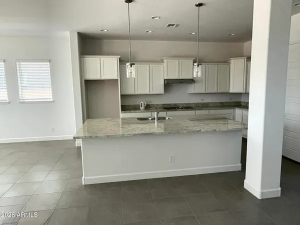 a kitchen with stainless steel appliances granite countertop a sink a stove and a refrigerator