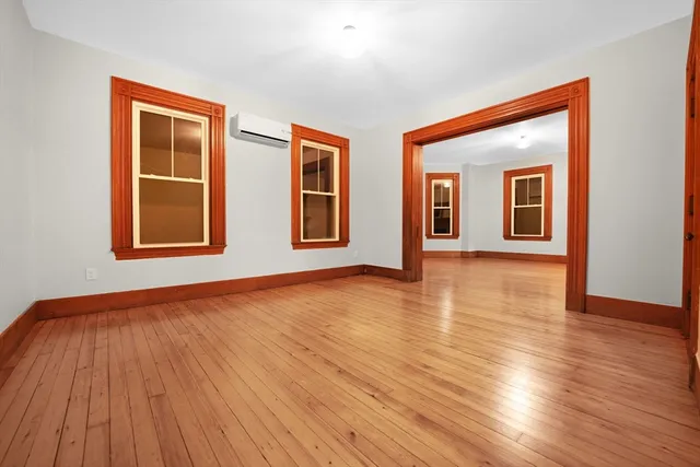 a view of a room with wooden floor
