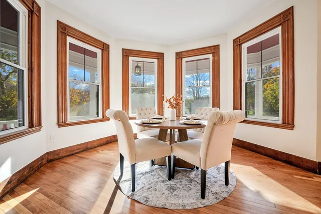 a living room with furniture a fireplace and wooden floor