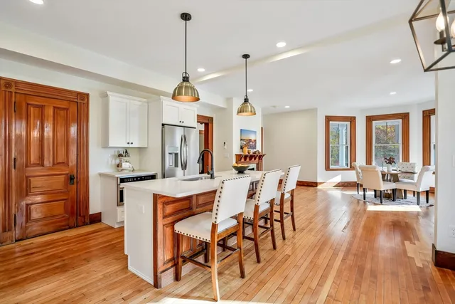 a very nice looking living room with wooden floor and furniture
