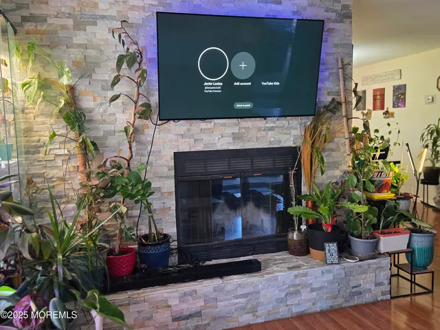 a living room with a fireplace and flowers