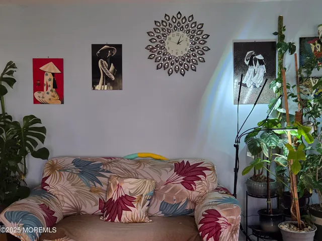 a bedroom with a bed and a potted plant