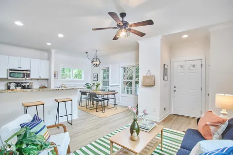 a living room with furniture and kitchen view