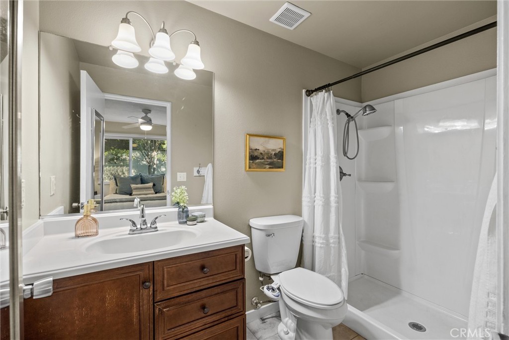 1 Parkhurst Street Chico, CA 95928 - Photo 18 of 52 a bathroom with a sink a toilet a mirror a vanity and shower