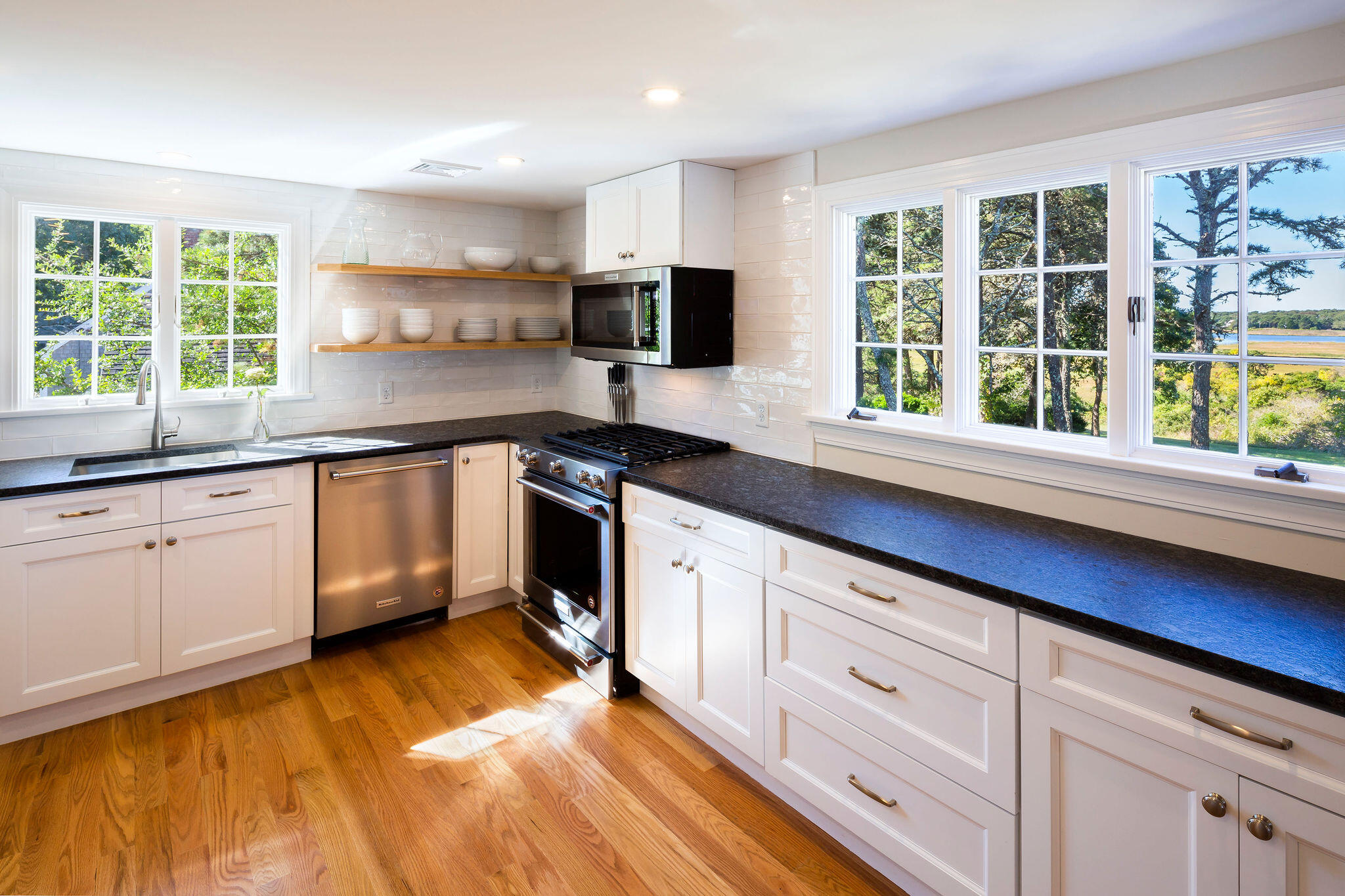 20 Hardings Beach Road Chatham, MA 02633 - Photo 6 of 20 a kitchen with granite countertop a sink cabinets stainless steel appliances and a window