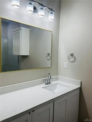 a bathroom with a sink and a mirror