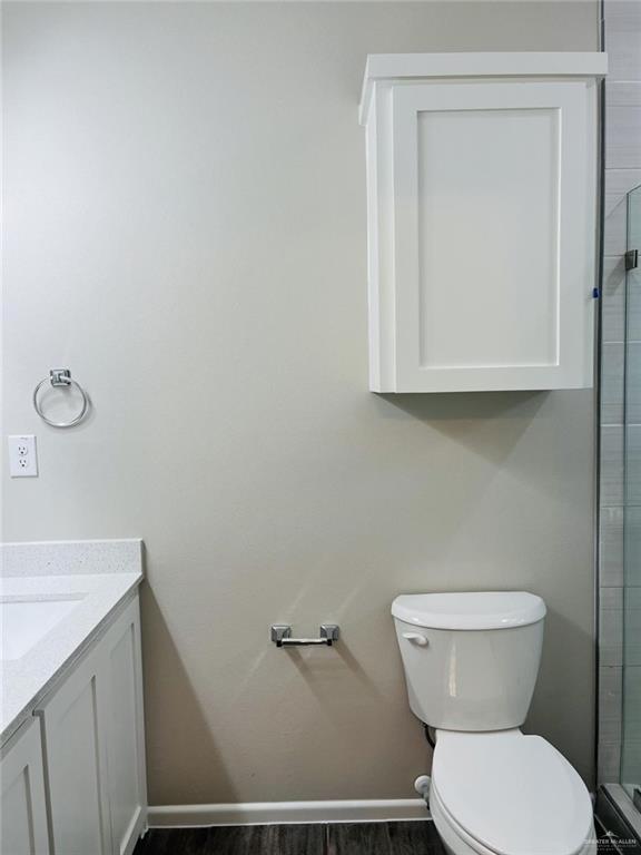 1212 Sucre Drive, Unit 2 Edinburg, TX 78541 - Photo 6 of 8 Bathroom featuring vanity, dark wood-style flooring, and a shower stall