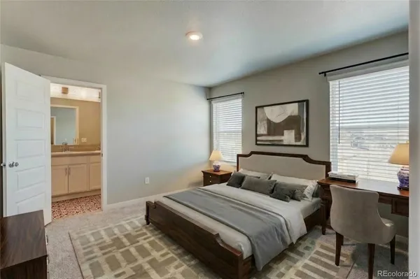 a bedroom with a bed and a chair