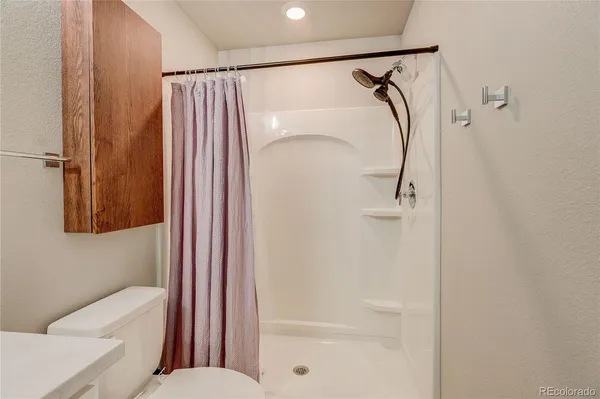 a bathroom with a shower and a toilet