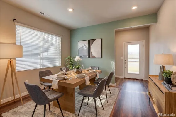 a view of a dining room with furniture and wooden floor