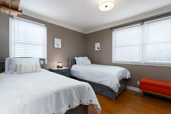 a bedroom with a bed and wooden floor