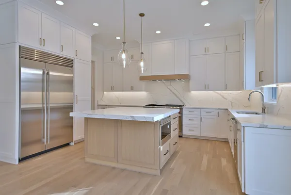 a kitchen with kitchen island a sink stainless steel appliances and cabinets