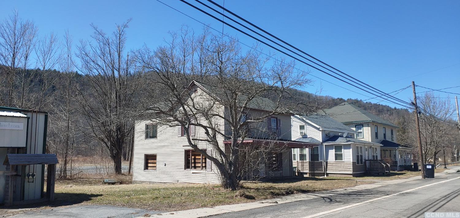14477 Main Street Prattsville, NY 12468 - Photo 1 of 8 a front view of a house with a yard