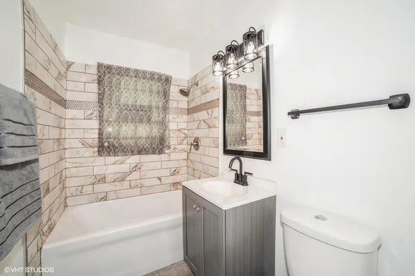 a bathroom with a sink a toilet and bathtub