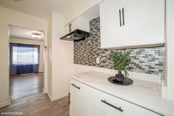 a view of a sink a mirror and window in a room