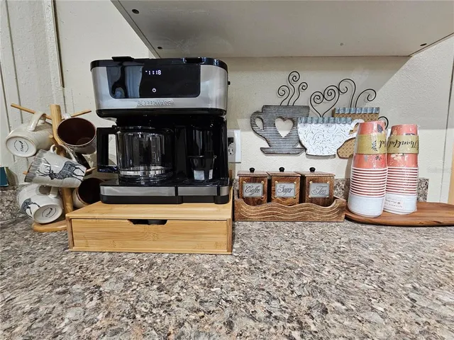 a kitchen with granite countertop stainless steel appliances a stove a microwave a sink and cabinets