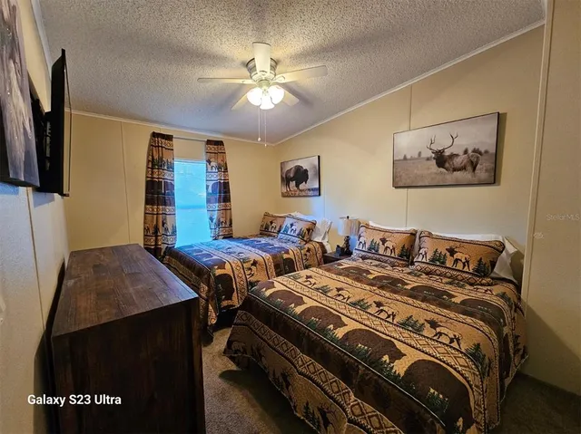 a bedroom with a bed and a painting on the wall