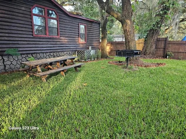a backyard of a house with table and chairs