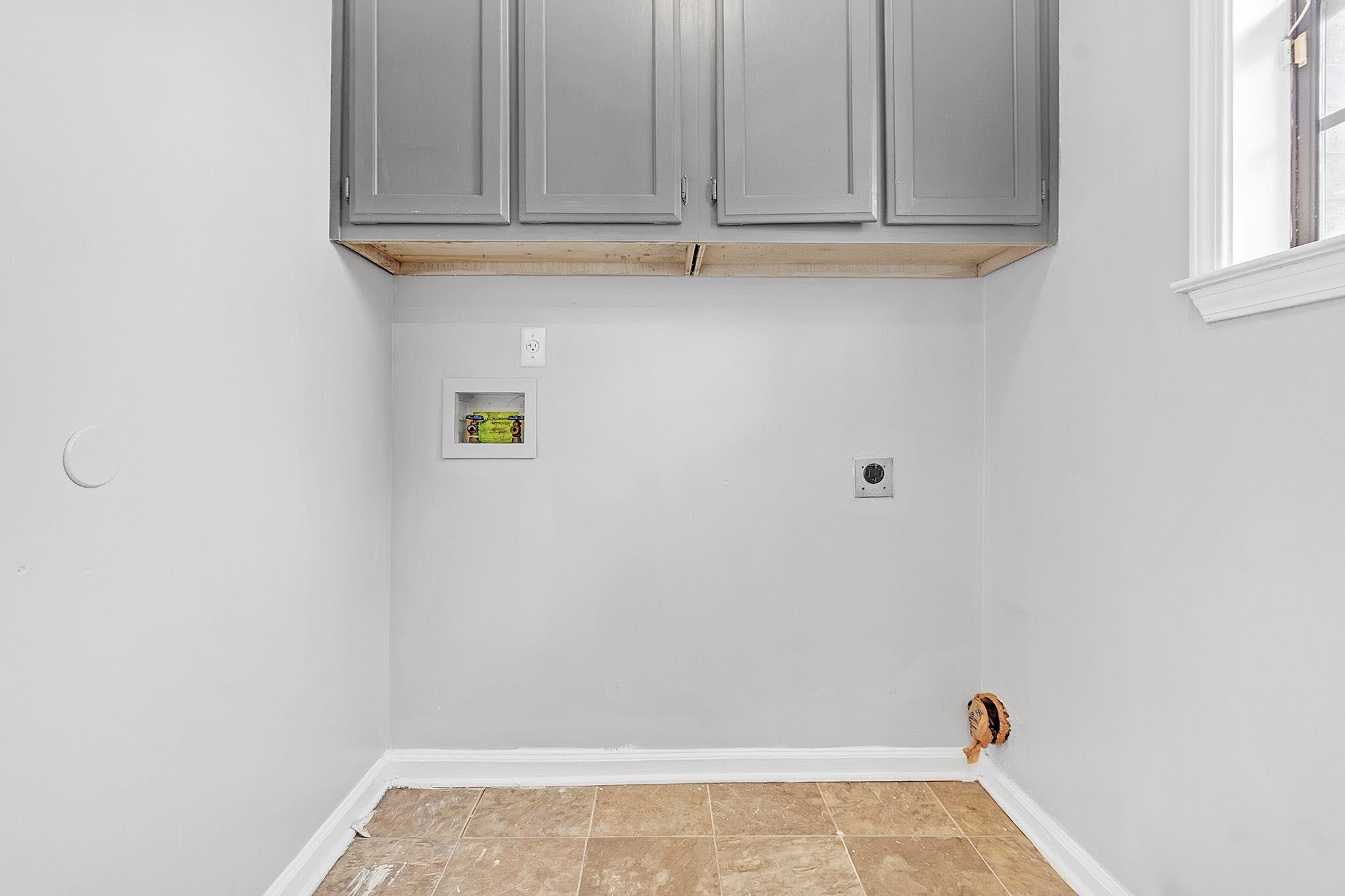 4788 Shadow View Lane Bartlett, TN 38002 - Photo 18 of 33 Laundry room featuring washer hookup, electric dryer hookup, baseboards, and cabinet space