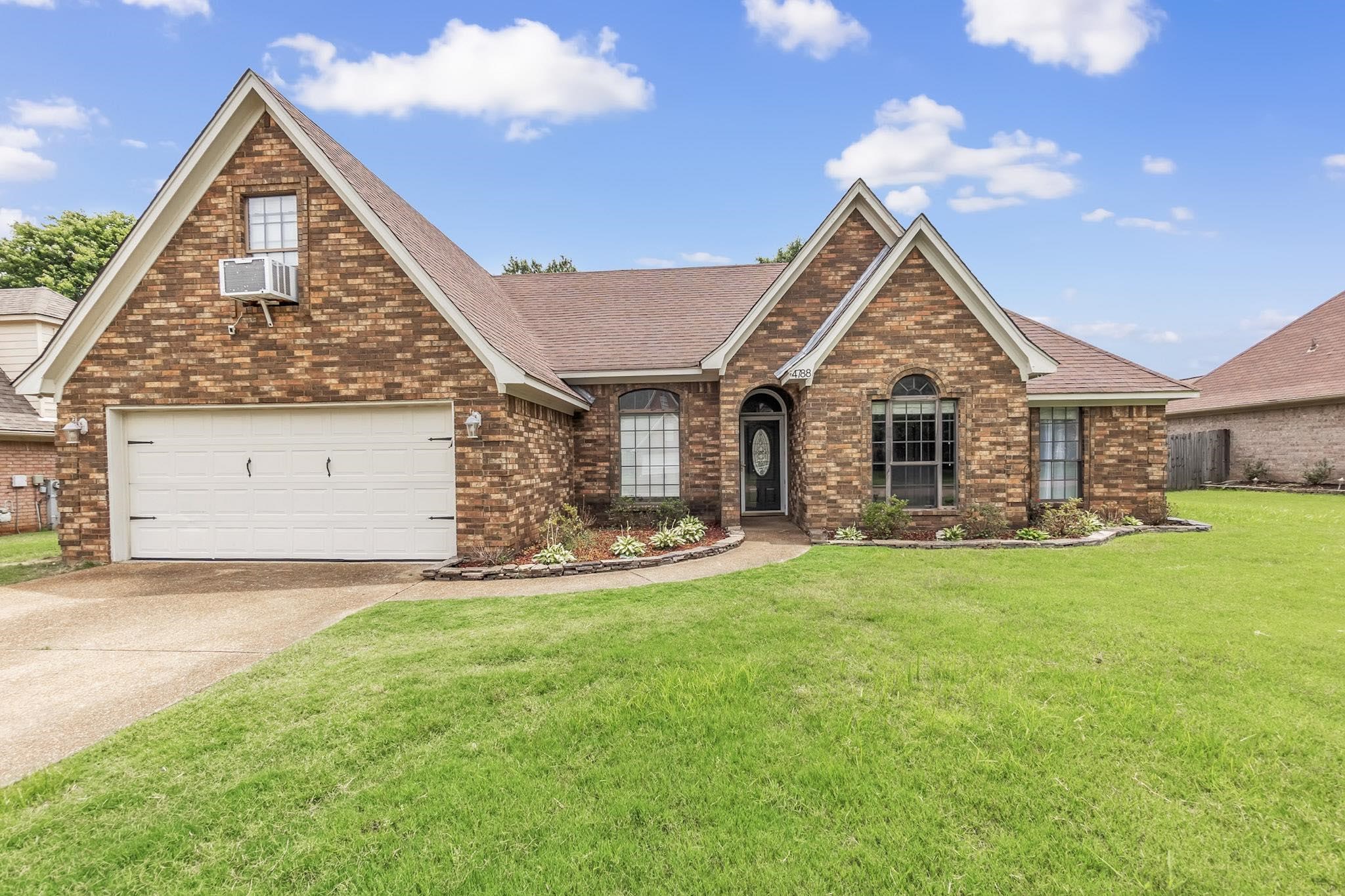 4788 Shadow View Lane Bartlett, TN 38002 - Photo 3 of 33 View of front facade with brick siding, a front lawn, roof with shingles, driveway, and cooling unit