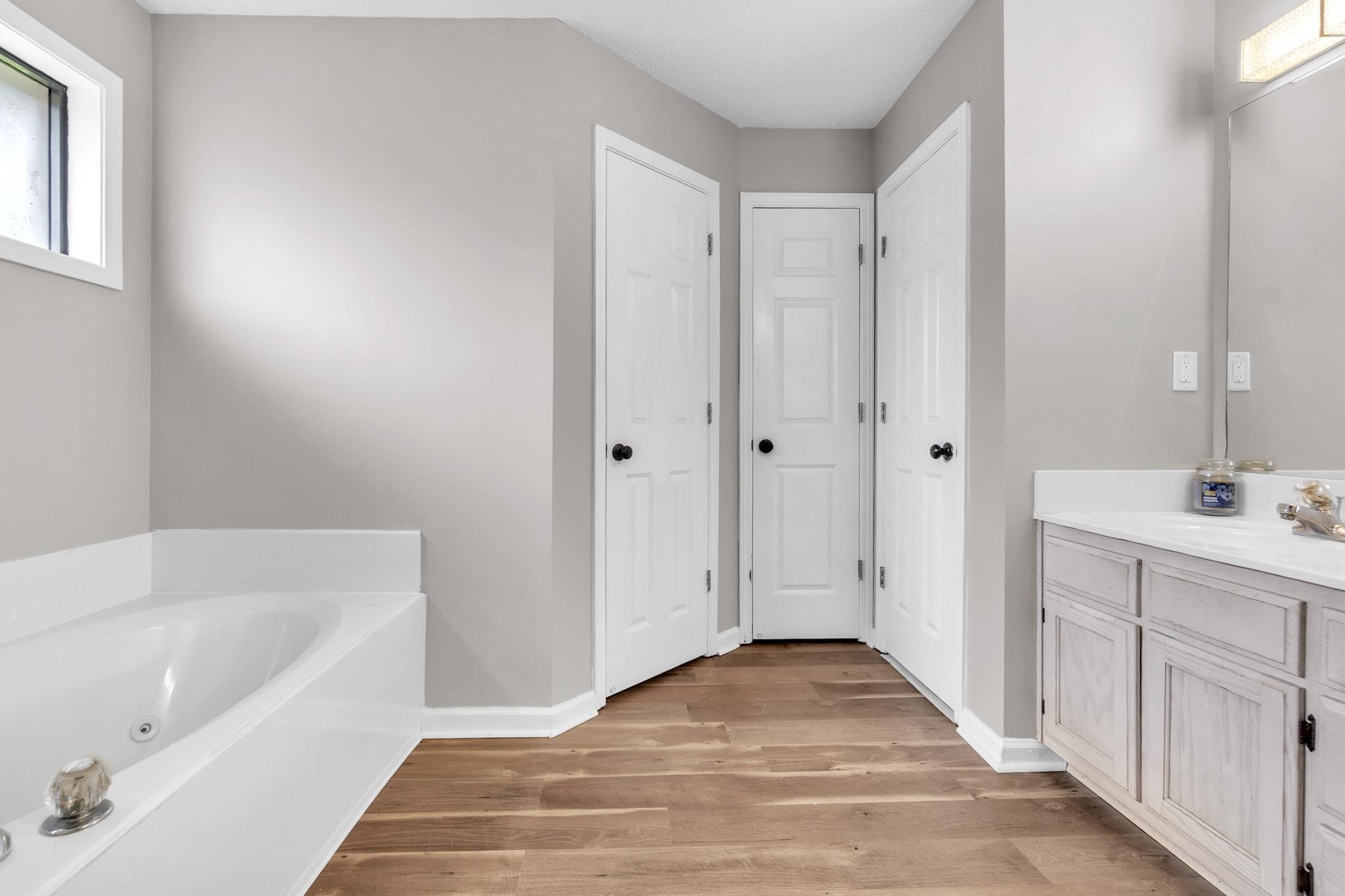 4788 Shadow View Lane Bartlett, TN 38002 - Photo 33 of 33 Full bath with vanity, a jetted tub, and wood finished floors