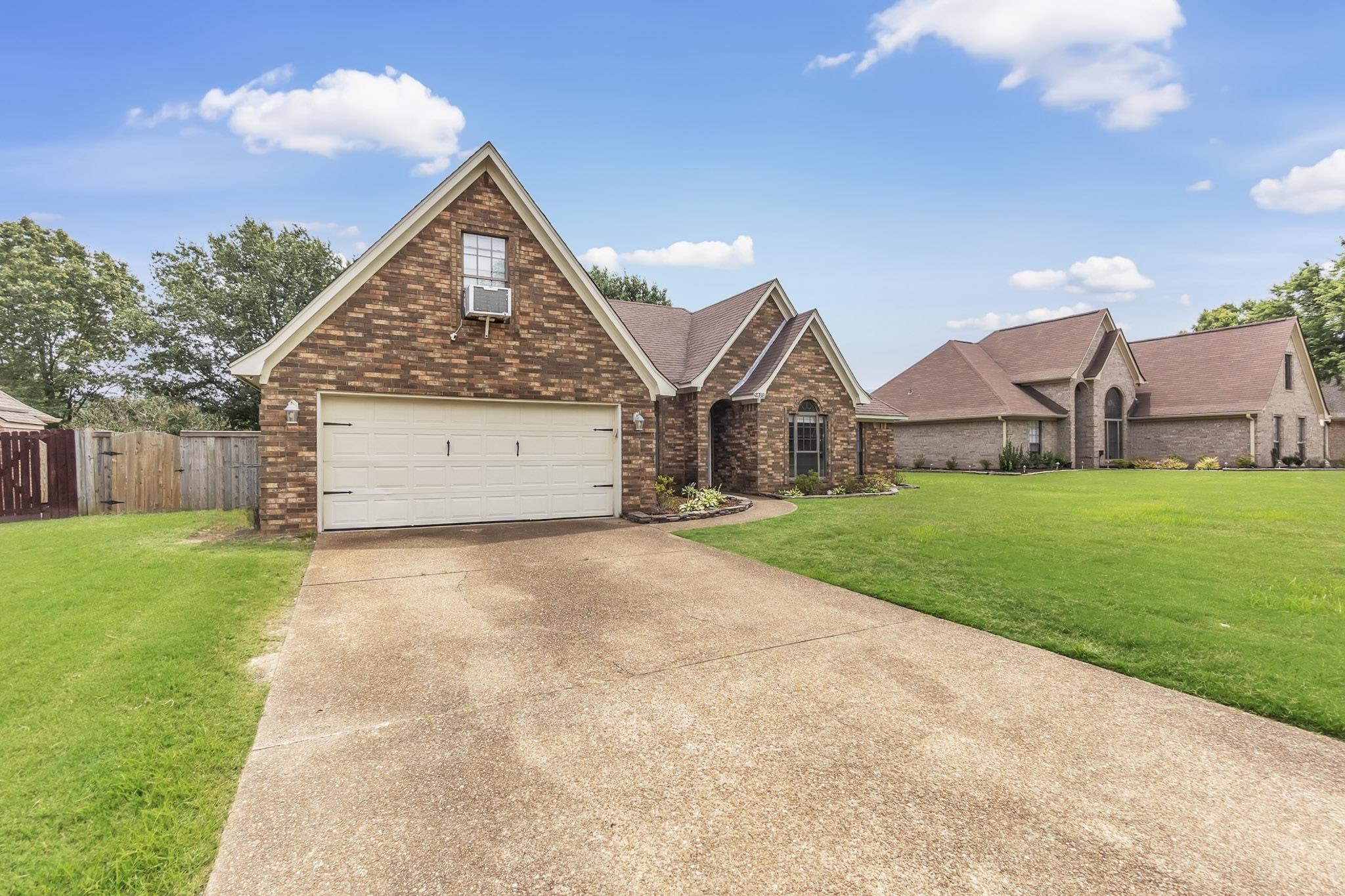 4788 Shadow View Lane Bartlett, TN 38002 - Photo 6 of 33 View of front of home with brick siding, concrete driveway, cooling unit, a shingled roof, and a garage