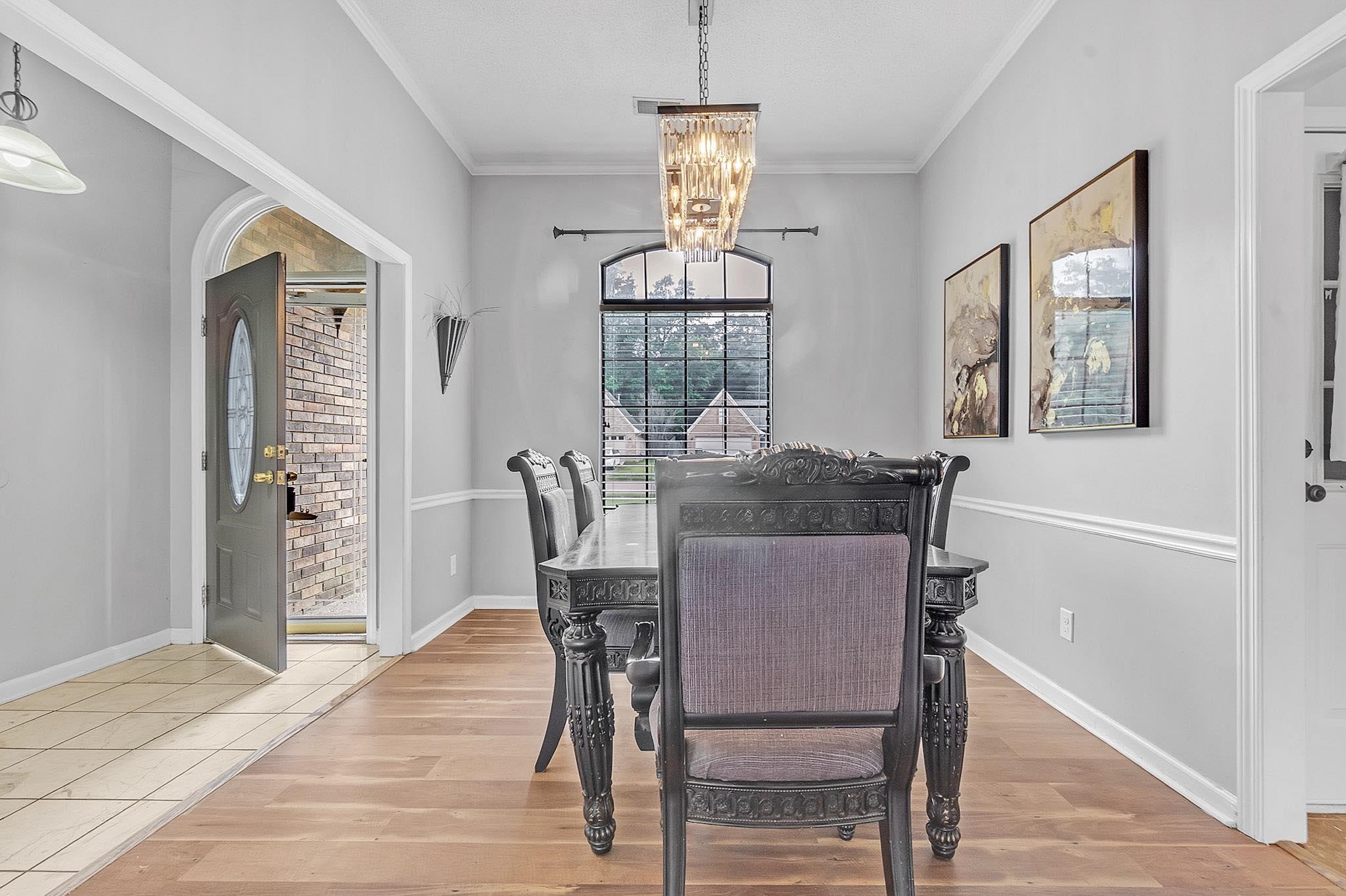 4788 Shadow View Lane Bartlett, TN 38002 - Photo 10 of 33 Dining room featuring a chandelier, ornamental molding, wood finished floors, and baseboards