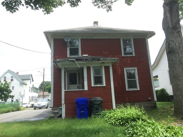 370 Nottingham Street Springfield, MA 01104 - Photo 3 of 17 a view of a brick house with a yard potted plants and a table