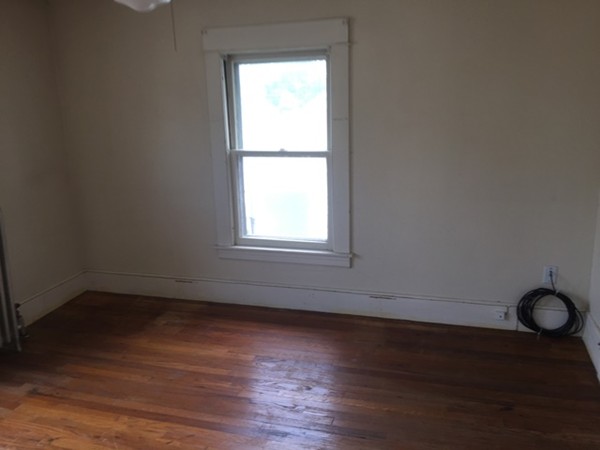 370 Nottingham Street Springfield, MA 01104 - Photo 10 of 17 an empty room with wooden floor and windows