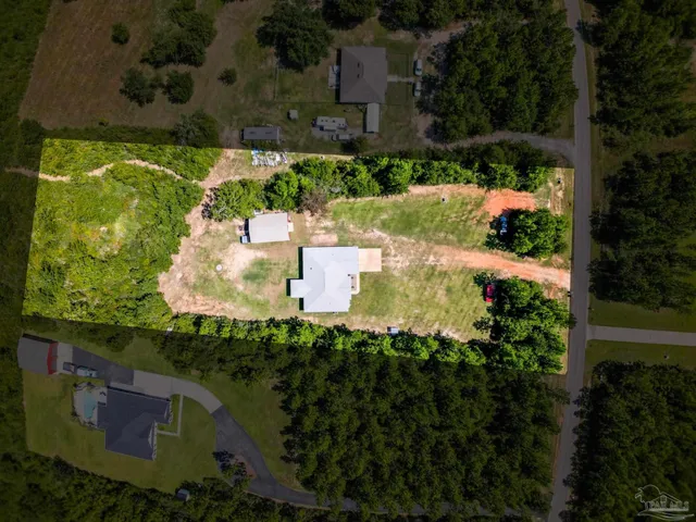 an aerial view of residential house with outdoor space