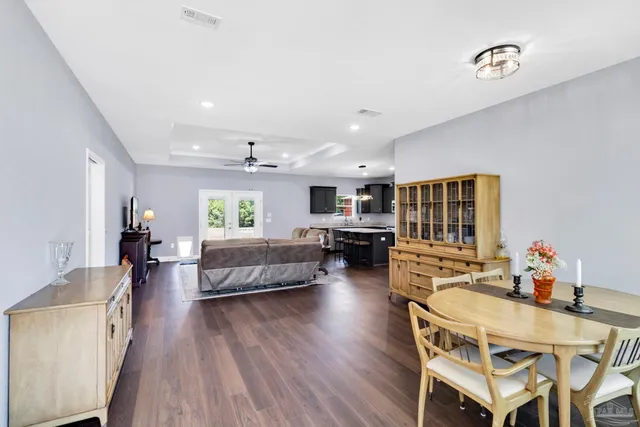 a living room with furniture a fireplace and a large window