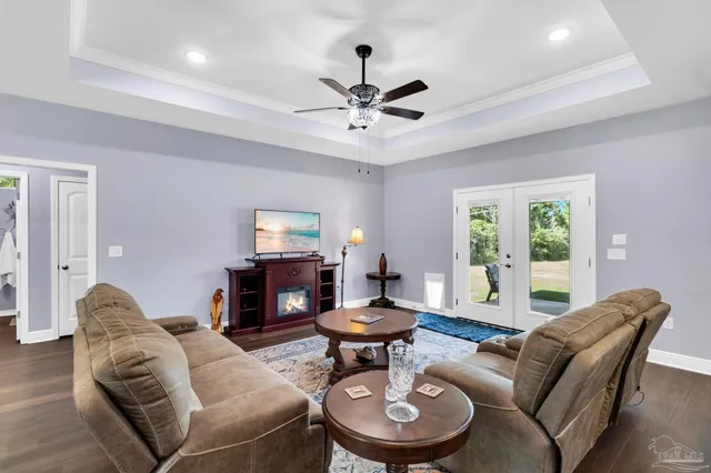 a kitchen with stainless steel appliances granite countertop a stove a refrigerator a sink a dining table and chairs