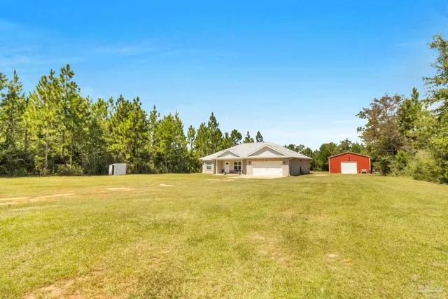 a view of a large body of water with a house in the background