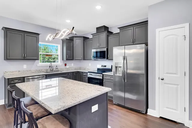 a bedroom with a bed and a fireplace with a chair