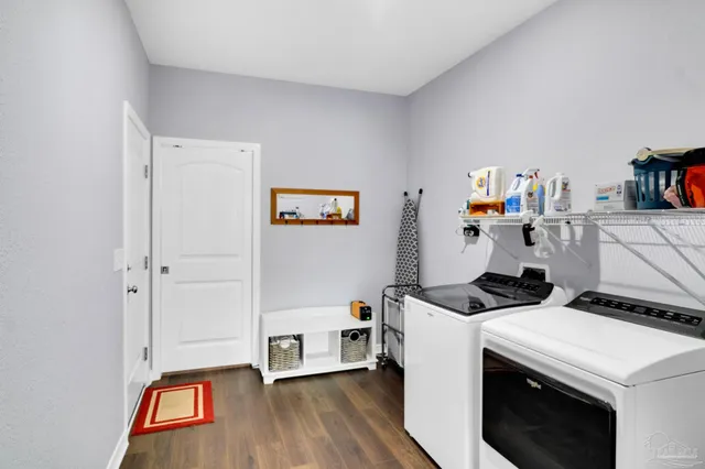 a spacious bedroom with a bed and a flat screen tv