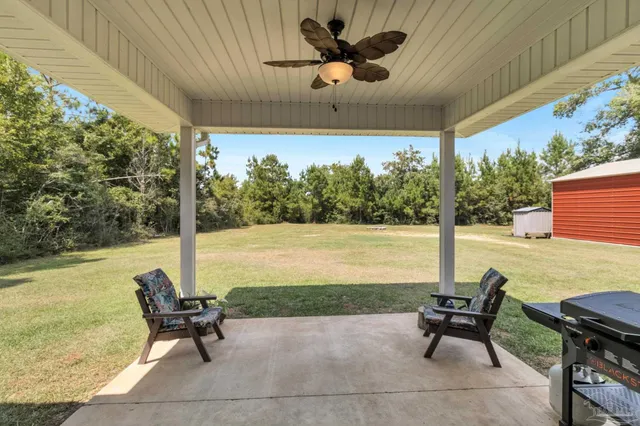 a aerial view of a house with a yard basket ball court and outdoor seating