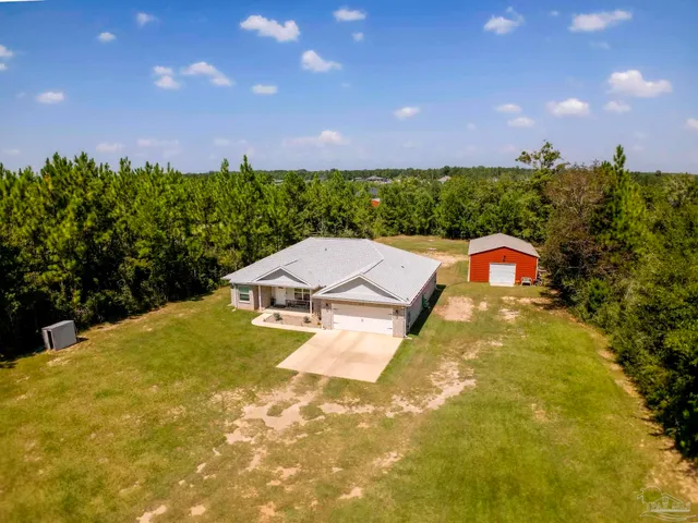 an aerial view of residential house with outdoor space