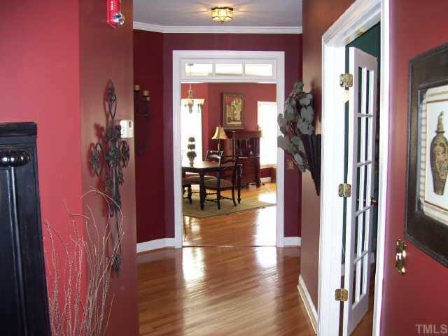 7520 Lead Mine Road Raleigh, NC 27615 - Photo 2 of 10 a view of hallway with livingroom and wooden floor