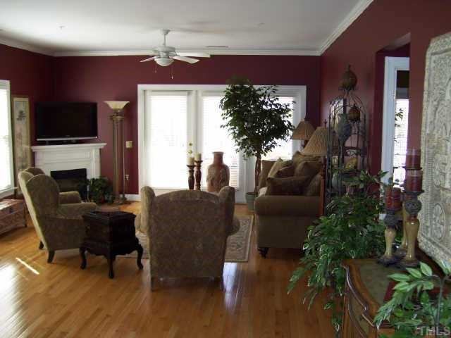7520 Lead Mine Road Raleigh, NC 27615 - Photo 3 of 10 a living room with furniture a flat screen tv and a potted plant