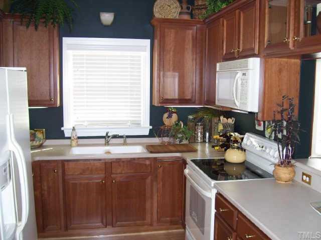 7520 Lead Mine Road Raleigh, NC 27615 - Photo 5 of 10 a kitchen with a sink and a stove top oven