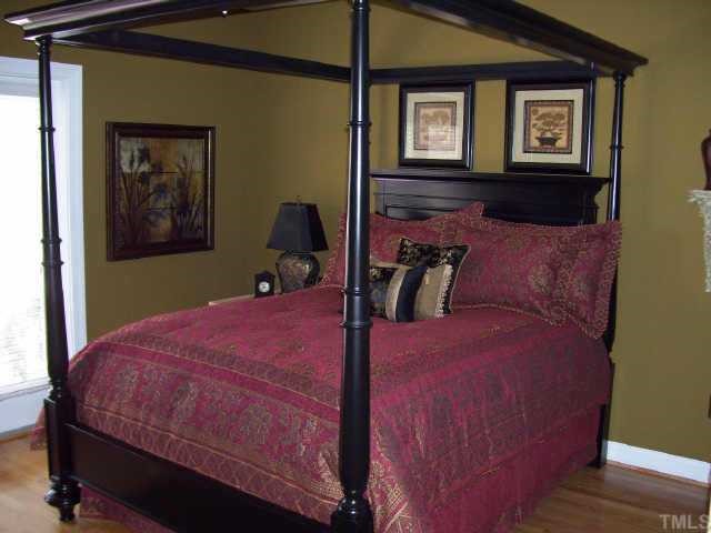 7520 Lead Mine Road Raleigh, NC 27615 - Photo 6 of 10 a bedroom with a bed and wooden floor