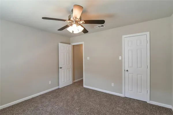 a view of a chandelier fan and entryway